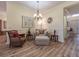 Sitting area with comfy chair and ottoman, hardwood floors, and view of entryway at 4139 63Rd E Ter, Sarasota, FL 34243