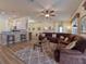 Spacious living room with a sectional sofa, large windows, and hardwood floors at 4139 63Rd E Ter, Sarasota, FL 34243