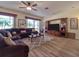 Living room with sectional sofa, hardwood floors, built-in entertainment center, and large windows at 4139 63Rd E Ter, Sarasota, FL 34243