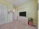 Bedroom with dresser and TV at 4139 63Rd E Ter, Sarasota, FL 34243
