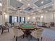 Game room with multiple card tables and comfortable chairs at 4139 63Rd E Ter, Sarasota, FL 34243