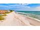 Aerial of beach with waves, sand, and beachfront buildings at 4818 61St Avenue W Ter, Bradenton, FL 34210