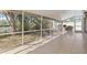 Screened porch with tiled floor and backyard view at 4818 61St Avenue W Ter, Bradenton, FL 34210