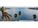 Serene view of calm water and palm trees at 543 Key Royale Dr, Holmes Beach, FL 34217