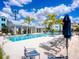 Community pool with lounge chairs and umbrellas at 2308 Lindstrom St, Sarasota, FL 34237