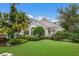 Beautiful house exterior with lush landscaping and a manicured lawn at 8223 Regents Ct, University Park, FL 34201