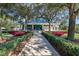 Inviting Tennis & Fitness Center entrance with landscaping at 8223 Regents Ct, University Park, FL 34201
