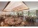 Spacious indoor dining room with hardwood floors and multiple tables at 8223 Regents Ct, University Park, FL 34201