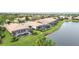 Aerial view of house with pool, lanai, and lake at 115 Winding River Trl, Bradenton, FL 34212