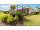 Enclosed lanai and garden in the backyard of this well-maintained home at 115 Winding River Trl, Bradenton, FL 34212