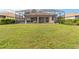 The backyard features a large lawn and screened-in patio at 115 Winding River Trl, Bradenton, FL 34212