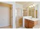 This bathroom includes a glass shower, a single sink, and vanity with good lighting at 115 Winding River Trl, Bradenton, FL 34212