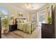 This bedroom has hardwood floors, neutral walls, and a sliding glass door at 115 Winding River Trl, Bradenton, FL 34212