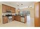 This kitchen features stainless steel appliances, granite countertops, and wooden cabinets at 115 Winding River Trl, Bradenton, FL 34212