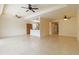 The spacious living room features tile floors, a ceiling fan, and an open view of the kitchen at 115 Winding River Trl, Bradenton, FL 34212