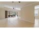 Expansive living area with tile flooring and sliding doors opening to a screened patio, perfect for entertaining at 115 Winding River Trl, Bradenton, FL 34212