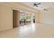The living room has tile flooring and a large sliding glass door leading to the outside patio at 115 Winding River Trl, Bradenton, FL 34212