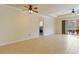 Spacious living room with tile flooring, ceiling fans, and sliding glass doors leading to an outdoor patio at 115 Winding River Trl, Bradenton, FL 34212