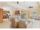 Open-concept living space with kitchen, dining area, and living room with neutral tones and stylish decor at 115 Winding River Trl, Bradenton, FL 34212