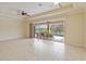 Spacious living area with tile flooring and sliding glass doors leading to the outdoor patio and pool at 115 Winding River Trl, Bradenton, FL 34212