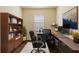 Office with two desks, a bookcase, and a comfortable chair at 115 Winding River Trl, Bradenton, FL 34212