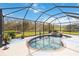 Screened-in pool and spa offer a relaxing view of the lush greenery surrounding the home at 115 Winding River Trl, Bradenton, FL 34212