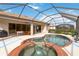 Screened-in pool and spa with brick trim and an outdoor dining area, perfect for relaxing and entertaining at 115 Winding River Trl, Bradenton, FL 34212