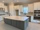 Modern kitchen with large island, white cabinets, and stainless steel appliances at 15821 San Lazzaro Ave, Bradenton, FL 34211