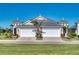 Two-car garage home with gray roof and landscaping at 251 Okeeffe Cir, Bradenton, FL 34212