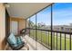 Screened in balcony with seating and view of mature landscaping at 3006 Caring Way # 224, Port Charlotte, FL 33952