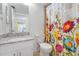 Bathroom featuring a granite vanity, mirror, and shower with floral curtain at 3006 Caring Way # 224, Port Charlotte, FL 33952