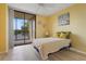 Bedroom featuring a sliding glass door to a balcony and neutral decor at 3006 Caring Way # 224, Port Charlotte, FL 33952