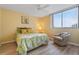 Comfortable bedroom with a ceiling fan, bright window, and a cozy chair at 3006 Caring Way # 224, Port Charlotte, FL 33952