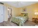 Cozy bedroom with an ensuite bathroom, floral bedding, and ample natural light at 3006 Caring Way # 224, Port Charlotte, FL 33952
