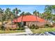 Charming clubhouse surrounded by palm trees, offering community amenities and a welcoming entrance at 3006 Caring Way # 224, Port Charlotte, FL 33952