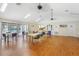 Spacious common room with hardwood floors, tables, chairs, and view of the community pool at 3006 Caring Way # 224, Port Charlotte, FL 33952