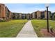 Beautifully landscaped community with walking paths, lush lawns, and well-maintained buildings at 3006 Caring Way # 224, Port Charlotte, FL 33952