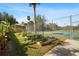 Community garden with raised beds and a tennis court in the background at 3006 Caring Way # 224, Port Charlotte, FL 33952