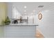 Bright kitchen featuring white cabinets, granite countertops, and stainless steel appliances at 3006 Caring Way # 224, Port Charlotte, FL 33952