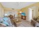 Open living space with wood-look flooring and a view into the kitchen and dining area at 3006 Caring Way # 224, Port Charlotte, FL 33952