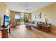 Inviting living room with comfortable seating, ceiling fan, and sliding glass doors to the balcony at 3006 Caring Way # 224, Port Charlotte, FL 33952