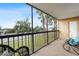 Relaxing screened patio featuring comfortable seating and a view of palm trees and the neighborhood at 3006 Caring Way # 224, Port Charlotte, FL 33952