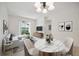 Living room features a staged modern sofa and round dining table at 4260 Central Sarasota Pkwy # 213, Sarasota, FL 34238