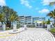 Modern condo building with gated entrance at 4651 Gulf Of Mexico Dr # 402, Longboat Key, FL 34228