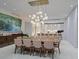 Modern dining room with a large table, chandelier, and ocean views at 4651 Gulf Of Mexico Dr # 402, Longboat Key, FL 34228