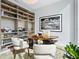 Bright home office with a custom desk, built-in shelving, and comfortable seating at 4651 Gulf Of Mexico Dr # 402, Longboat Key, FL 34228