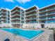 Resort-style pool with plenty of lounge chairs at 4651 Gulf Of Mexico Dr # 402, Longboat Key, FL 34228