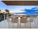 Oceanfront dining patio, with seating for six and stunning sunset views at 4651 Gulf Of Mexico Dr # 402, Longboat Key, FL 34228