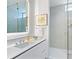 Modern bathroom with a glass shower, white vanity, and sleek fixtures at 4651 Gulf Of Mexico Dr # 402, Longboat Key, FL 34228