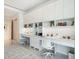 Bright office space with two desks, built-in shelving, and abundant natural light at 4651 Gulf Of Mexico Dr # 402, Longboat Key, FL 34228